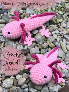 two pink crocheted animals laying on top of rocks and gravel with the words crochet axoloi written below