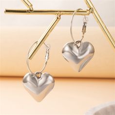 You'll love these heart earrings that will add a sweet touch to any ensemble. 1.06" W x 2.36" L Silver-plated copper Trendy Heart Charm Earrings For Mother's Day, Trendy Valentine's Day Hoop Earrings, Silver Nickel-free Hoop Earrings For Valentine's Day, Trendy Metal Heart-shaped Hoop Earrings, Heart Shaped Metal Earrings For Valentine's Day, Trendy Nickel-free Hoop Earrings For Valentine's Day, Heart-shaped Metal Earrings For Valentine's Day, Trendy Heart-shaped Hoop Earrings For Valentine's Day, Trendy Hoop Earrings For Valentine's Day