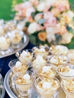 small desserts are arranged on silver trays