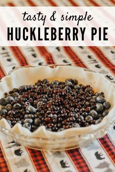 a pie filled with blueberries sitting on top of a red and white table cloth