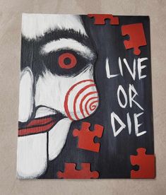 a piece of art that says live or die with a clown's face painted on it