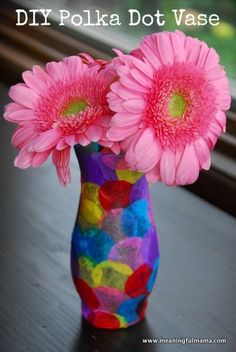 two pink flowers in a colorful vase with the words, diy polka dot vase