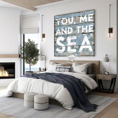 a bedroom with a bed, fireplace and artwork on the wall that says you me and the sea