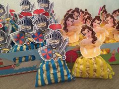 some paper cut outs are sitting on the floor next to boxes with princesses in them