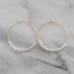 With white moonstone beads (that are said to be a feminine and sensual gemstone) these hoops will give you all the girl power vibes you need. 45mm (about 1.75") gold-filled or sterling silver hoops with White Moonstone gemstone beads packaged on a kraft earring card in a clear resealing bag gold-filled hoops are lead-free gold over brass. Gold-filled has much more gold than gold-plated and will last longer without tarnishing. Not sure which gemstone to choose? This blog post might help: Get Your White 14k Gold Filled Hoop Earrings, White 14k Gold Filled Hoop Jewelry, Dainty White Hoop Jewelry, Round Moonstone Hoop Earrings As A Gift, Handmade White 14k Gold Filled Hoop Earrings, Handmade 14k Gold Filled White Hoop Earrings, White Delicate Nickel-free Hoop Earrings, Delicate White Nickel-free Hoop Earrings, White Moonstone Earrings For Daily Wear