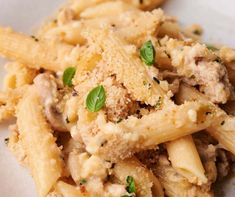 pasta with meat and parmesan cheese in a white bowl