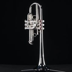 a silver trumpet on a black background