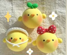 two yellow chickens with bows on their heads and one is wearing a red polka dot bow