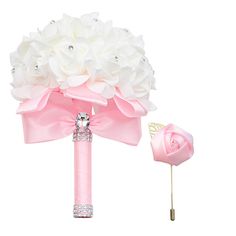 a pink and white bridal bouquet on a stick with a diamond brooch in the center