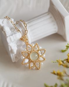 Luxurious and timeless, the Austyn Prehnite Sunflower Pendant Necklace is exquisitely crafted from 14K gold-filled metal, embedded with freshwater Pearls and delicate Cube Zirconia gems. Representing unconditional love, Prehnite amplifies one's inner awareness and intuition, making this piece an ideal addition to any ensemble. Suspended from a square "O" chain, finished with a spring clasp, this exquisite necklace elevates the wearer's style and sophistication. The length of necklace is approx. Sunflower Pendant, Wedding Jewellery Necklace, Unconditional Love, Wedding Necklace, Freshwater Pearls, Necklace Etsy, Wedding Jewelry, Gold Filled, Sunflower