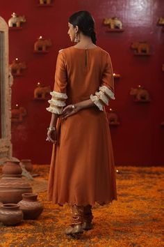 Burnt orange kurta with sequin, dori, bead embroidery in floral pattern on yoke. Paired with churidar and floral hand painted dupatta. - Aza Fashions Raw Silk Kurta With Gota Work For Puja, Designer Handloom Kurta For Navratri, Anarkali Handloom Sets For Puja, Anarkali Handloom Kurta For Puja, Transitional Handloom Kurta For Puja, Designer Handloom Salwar Kameez For Navratri, Handloom Semi-stitched Kurta For Navratri, Festive Traditional Wear Handloom Straight Kurta, Festive Handloom Traditional Wear Straight Kurta