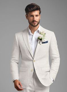 a man in a white suit with a boutonniere on his lapel