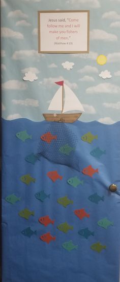 a door decorated with an image of a sailboat and some fish on the water