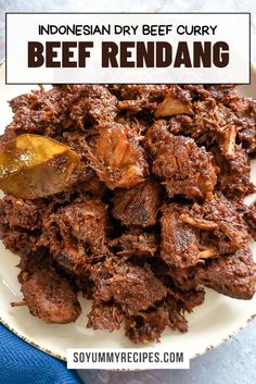 beef rendang on a white plate with text overlay