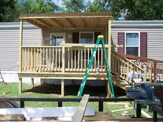 a mobile home with a porch and stairs