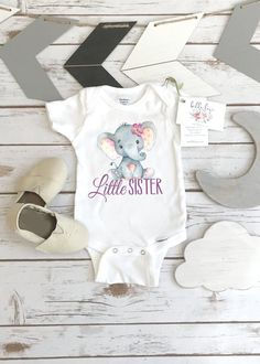 a baby bodysuit that says, little brother with an elephant on the front and back