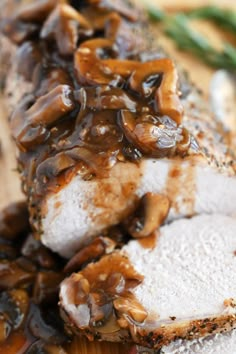 meatloaf with mushrooms and gravy on a cutting board