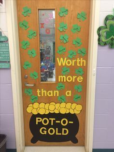 a door decorated with shamrocks and pot - o - gold written on the front