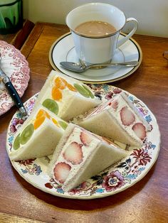 a plate that has some food on top of it next to a cup and saucer