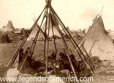 an old black and white photo of some people in front of a teepee tent