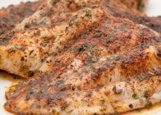 baked fish on a white plate sitting on a checkered tablecloth with text overlay