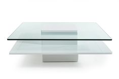 a glass and metal coffee table with two square tables on each side, in front of a white background