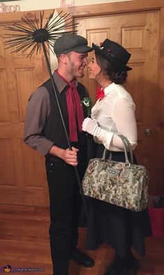 a man and woman are dressed up as the couple is kissing each other in front of a wooden door