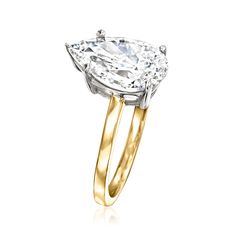 a yellow and white gold ring with a pear shaped diamond