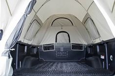 the interior of a white van with its doors open and it's cargo area opened