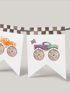 two cards with monster trucks on them hanging from a line