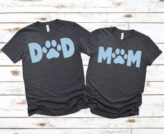 two matching shirts with the words dad and mom printed on them