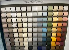 an assortment of different shades of paint on display in a store window with the words pure & original