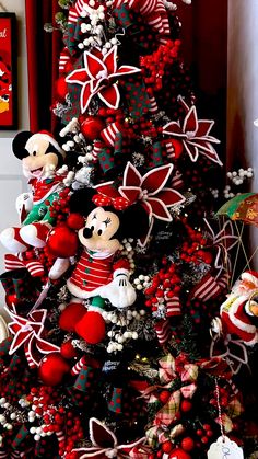 a christmas tree decorated with mickey mouse ornaments