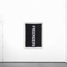 a black and white photo hanging on the wall next to a door with a sign that reads free fire fighters