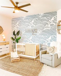 a baby's room with a crib, chair and dresser