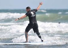 a man riding a surfboard on top of a wave in the ocean with his arms outstretched