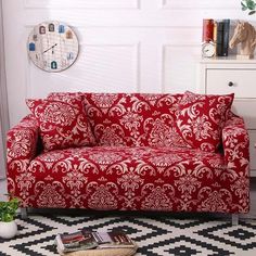 a living room with a red couch and black and white checkered floor