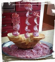 a plate that has some kind of food on it with meat in the shape of a boat