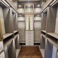 an empty walk in closet with lots of drawers