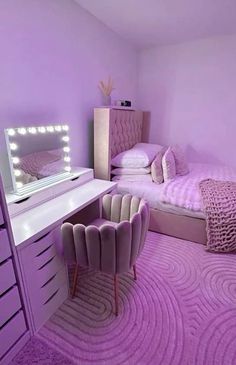 a bedroom with purple walls and carpeted flooring is pictured in this image, the room has a large mirror on the wall next to the bed