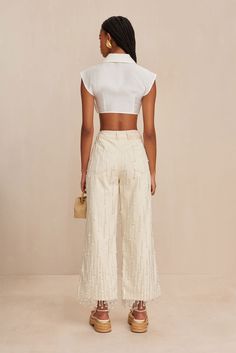 A wide-leg, cropped denim pant featuring layered double beaded, shimmering tassels throughout. — Glass beaded tassel detailing throughout — Front and back pockets — High-waist fit — Gold-toned studs with CG signature — Button and zip fly closure — Wide, cropped leg Theia Dresses, Willow Dress, Cropped Denim Pants, Cult Gaia, Beaded Tassels, Cropped Denim, Denim Pant, Minimal Fashion, Bridal Wear