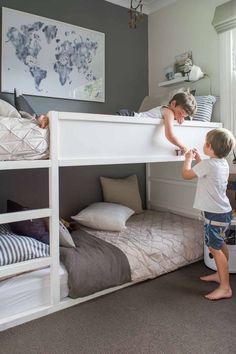 two children are playing with each other in their bunkbeds at the same time