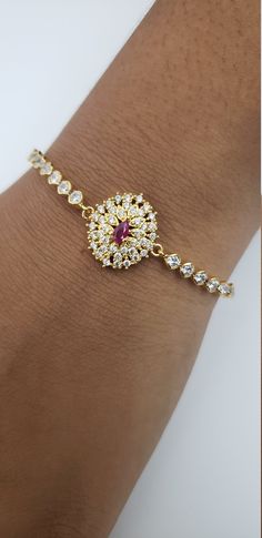 "The gold-filled adjustable bracelet is beautifully crafted with CZ stones, Semi-precious Ruby to give this bracelet a unique look paired with the ease and comfort of the sliding knot bracelet you are sure to love this little treasure. Simple modern, pretty jewelry for every day. Bracelet measures 10\" and is adjustable. One size fits many. Just slide the gold beads for your best fit. They are easy to put on, just pull the bead up and down the chain and you can adjust with ease. THE ULTIMATE PRE Adjustable Gold Plated Diamond Bracelet, Round Jewelry With Handset Cubic Zirconia Stones, Round Cubic Zirconia Jewelry With Handset Stones, Adjustable Diamond Bracelet With Sparkling Stones, Adjustable Round Diamond Bracelet With Sparkling Stones, Round Cubic Zirconia Bracelets With Stones, American Diamond Bracelet For Gift, Gold Bracelets With Handset Stones Gift, Dazzling Adjustable Hand-set Diamond Bracelet