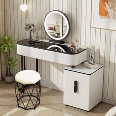 a white vanity table with a mirror and stool