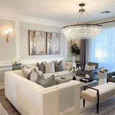 a living room filled with furniture and a chandelier