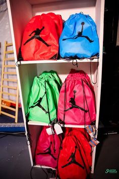 several bags are sitting on top of a shelf