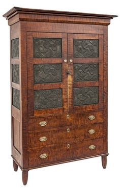 an old wooden cabinet with metal inserts on the door and drawers inlayed to it