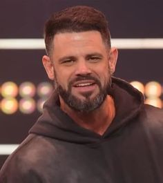 a man with a goatee wearing a black hoodie