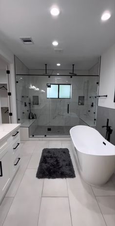 a large bathroom with a tub, sink and shower stall in the middle of it