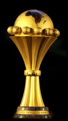 the golden trophy is on display in front of a black background